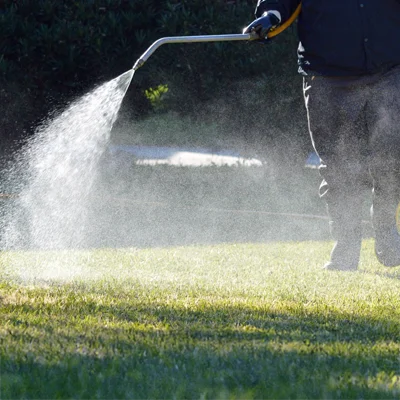 lawn technician aerating lawn