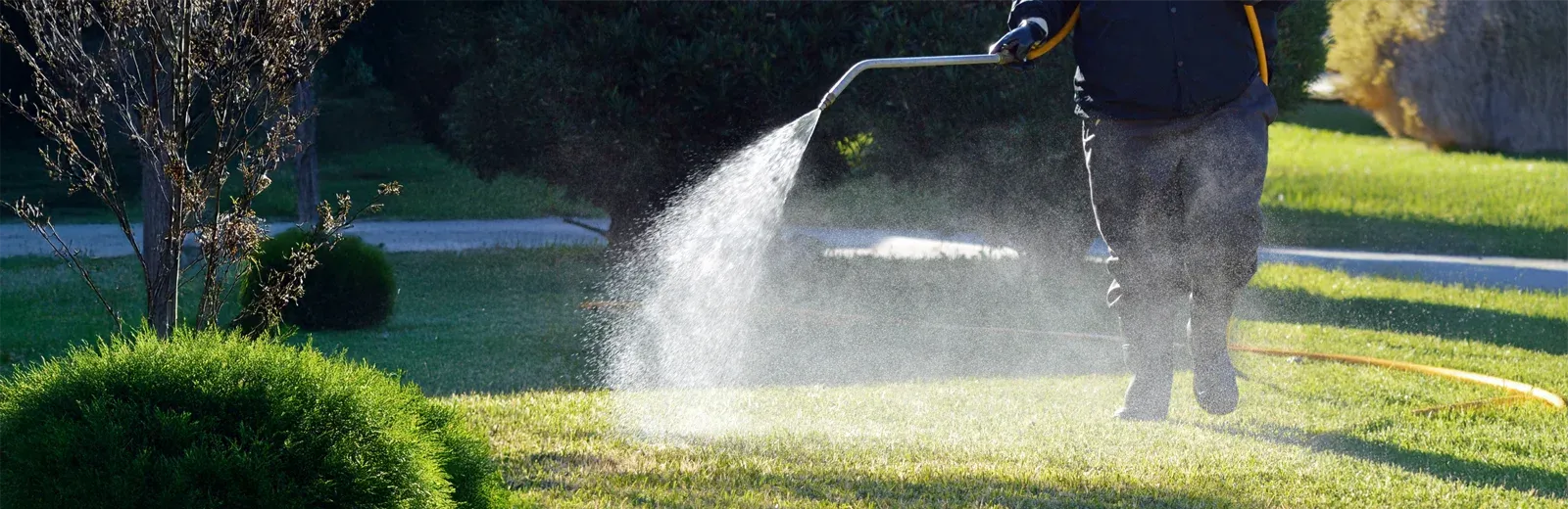 lawn technician spraying liquid aeration